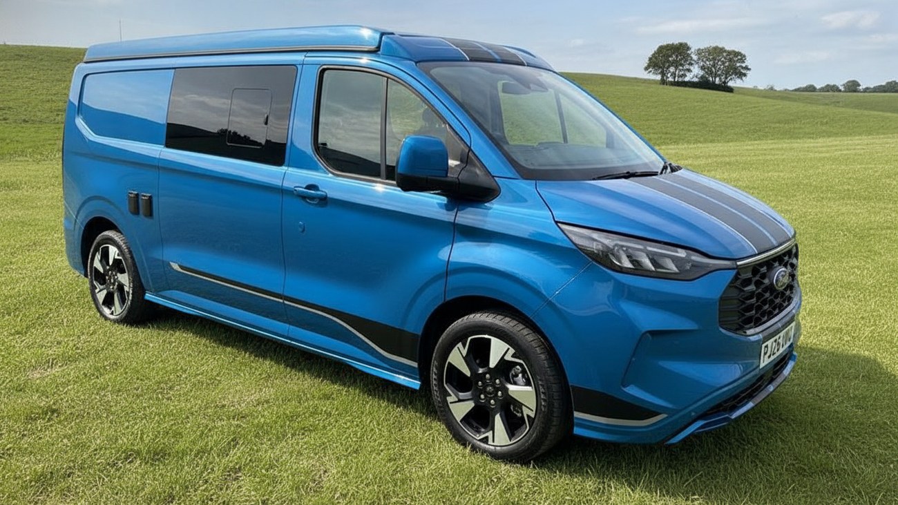 The full van parked on grass in open countryside